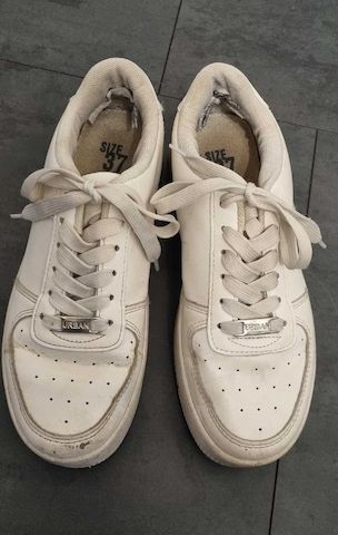 Getragene, abgenutzte weiße Turnschuhe zu verkaufen